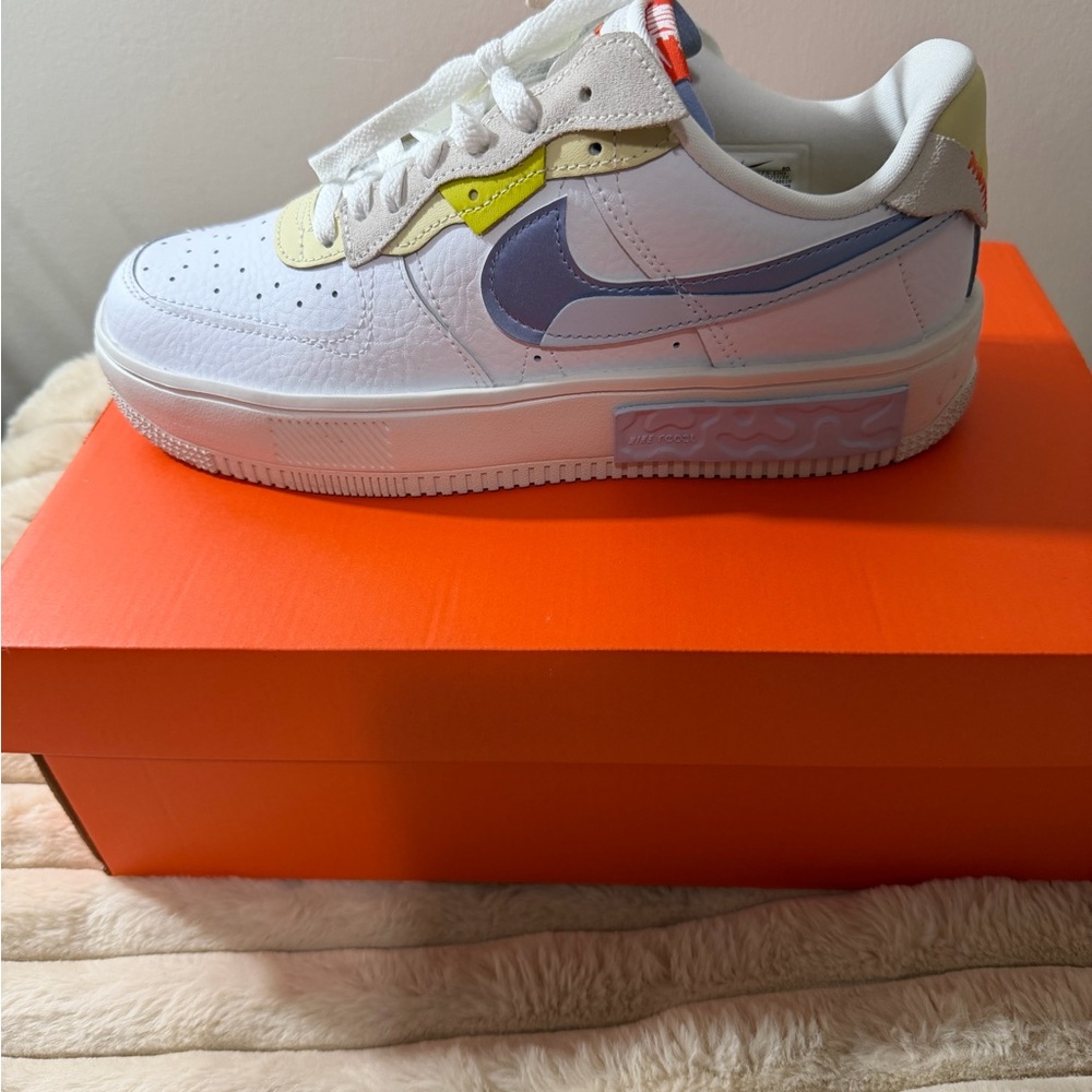 Nike White Sneakers with Blue and Yellow Accents